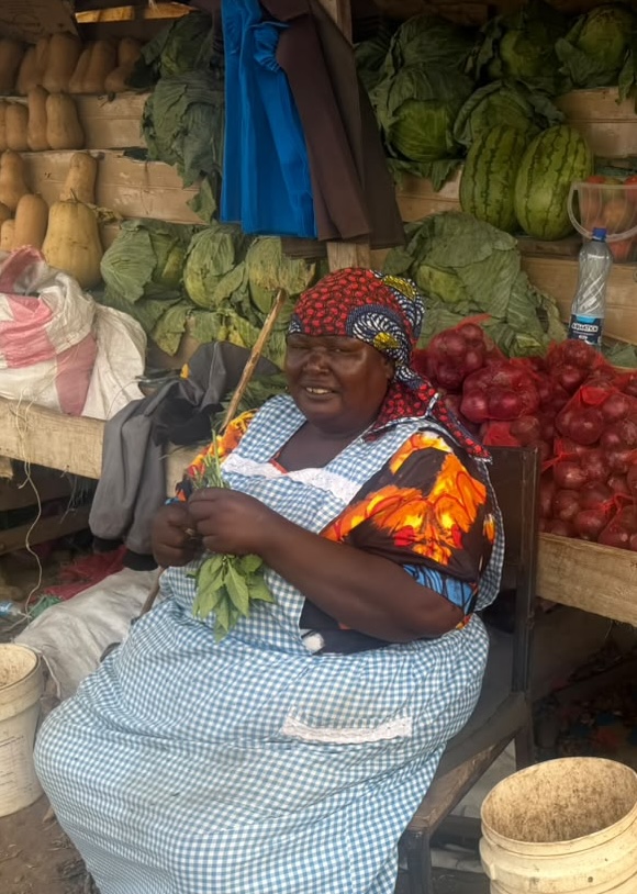 Sarah selling fresh produce at her colorful roadside kiosk